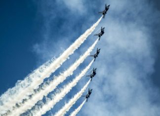 5 kleine Flugzeuge im Himmel, die im Rahmen einer Kunstflugshow fliegen