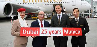 Emirates feiert 25 Jahre am Flughafen München: Joachim Sobottka-Rogalla, Emirates Airport Services Manager Munich (links), und Oliver Dersch, Senior Vice President Aviation, Flughafen München - flankiert von Mitgliedern der Emirates Kabinencrew.