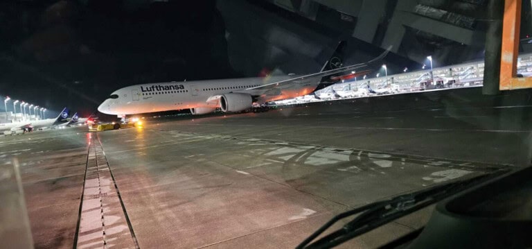 Munich Airport apron with Lufthansa Airbus A350 at night