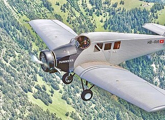 An aerial view of the Junkers F13 replica. The semi-open cockpit and the enclosed passenger cabin are clearly visible.