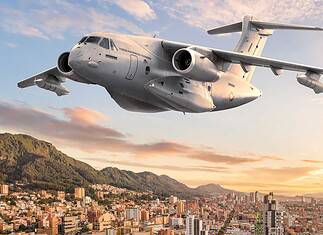 Colombia invests in Embraer’s KC-390 Millennium. Aerial view of an Embraer KC-390 in front of modern architecture in Bogotá, Colombia.