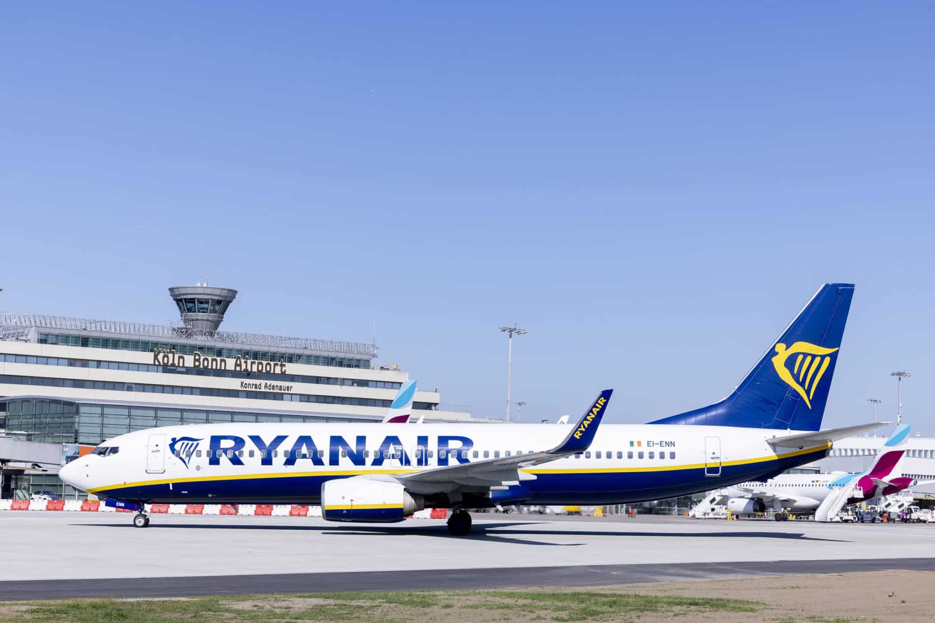 Ryanair aircraft at Cologne/Bonn Airport with the terminal in the background.